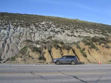 Photo of the San Andreas Fault near Gorman, California, showing rocks of the Pacific Plate (gray rocks on the