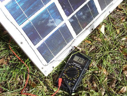 Here I am testing the current capacity of the panel, again in bright winter sunlight. My meter says 3.05 Amps short circuit current. That is right about what the cells are rated for.