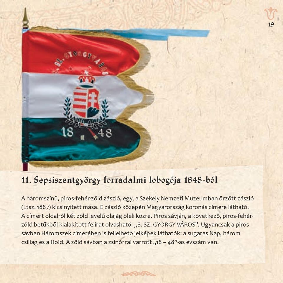 1887) kicsinyített mása. E zászló közepén Magyarország koronás címere látható. A címert oldalról két zöld levelű olajág öleli közre.