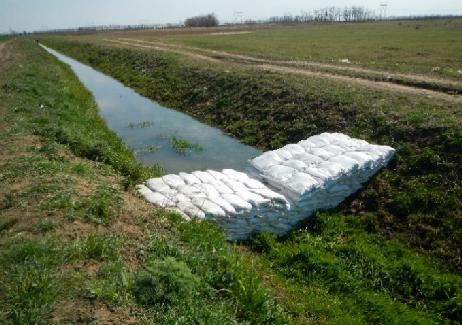 1. fotó. Ideiglenes mederelzárás a Simai-főfolyáson A csatornamedrekben az összesen visszatartható víz mennyisége megközelítőleg 1,5 millió m 3, amelyből 820 em 3 az Öreg-Túr vízkészletéből származik.