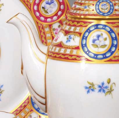 A porcelánok közepén gyöngysorral díszített, sötétkék szegélyű, ovális medallionban ﬁnom ecsetvonásokkal