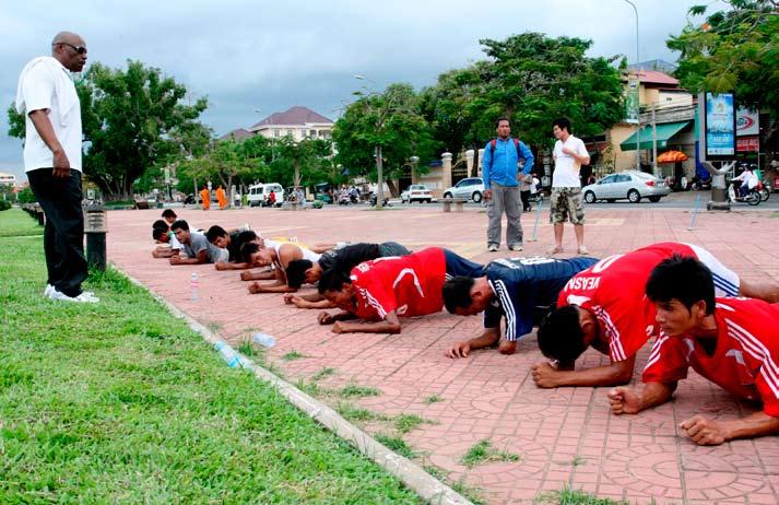 In Phnom Penh s historic Olympic Stadium the shrill calls of the resident bats blend well with the sound of sneakers hitting the wooden court at speed.