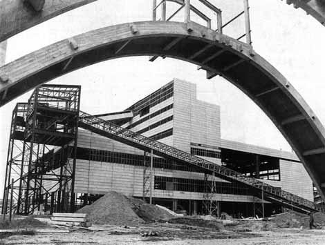 nyíláskiosztással alakították koherens építészeti struktúrává a téri és formai tekintetben egyaránt rendkívül szerteágazó gyártástechnológiai rendszert magába foglaló épületet.