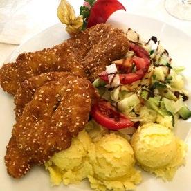 of pork with bread dumplings, potato dumplings and bavarian salad Konfitierte Schweinskamm mit Semmelknödeln, Kartoffelklösse und Bayerische Salat KONFITÁLT SERTÉSTARJA