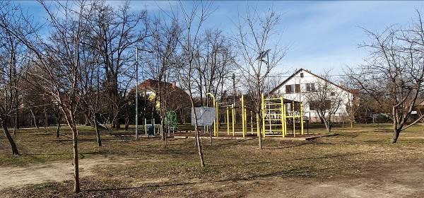 A játszótér nyugati oldalán álló kültéri fitnesz park a MegSzépülAVárosom Program 1 keretén belül készült,