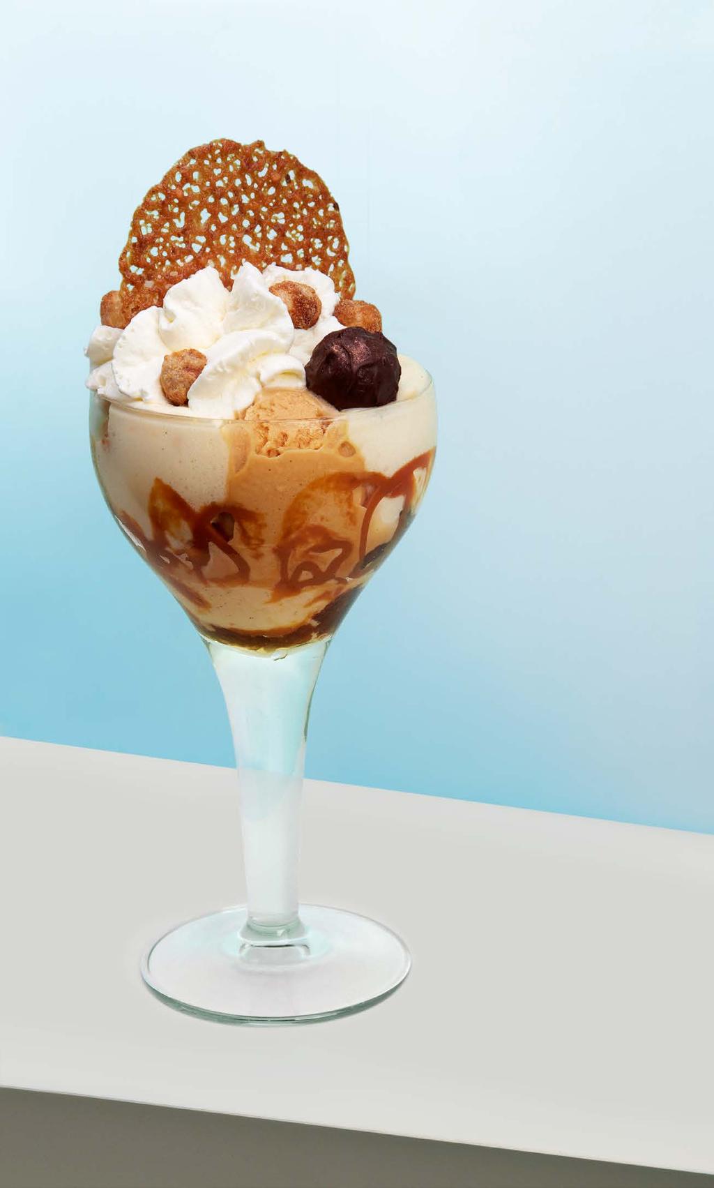 scoops of chocolate ice cream, 1 scoop of vanilla ice cream, vanilla foam, caramel sauce, whipped cream, popping candy, chocolate macaron Dobos Becher 2 Kugeln Dobos Torte, 2 Kugeln Schokoladeneis, 1