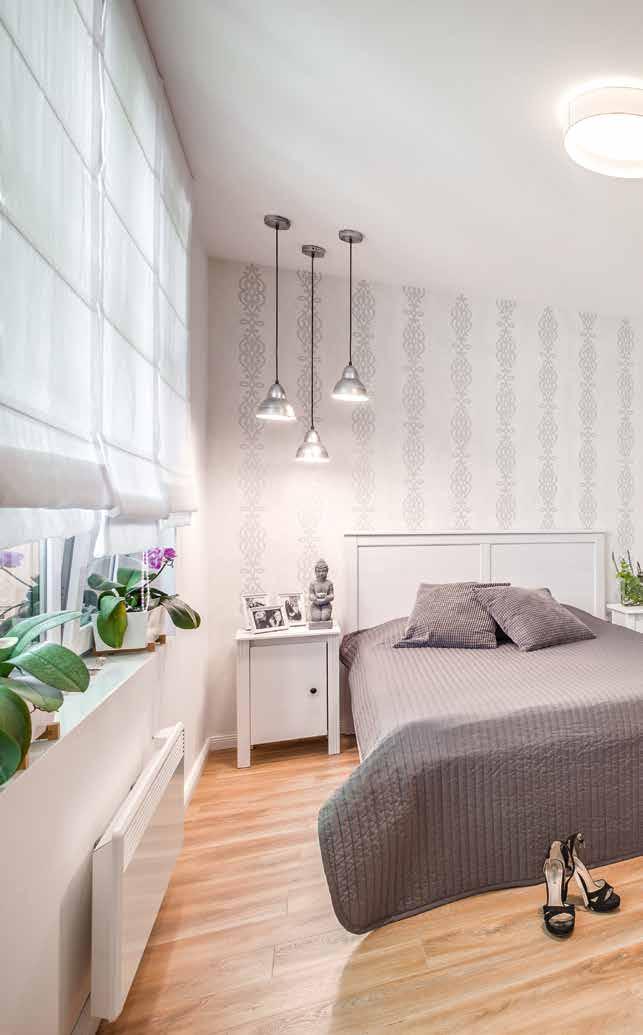 Az anyai hálószoba romantikus mintájú tapétája és a fehér szín itt is megjelenő eleganciája egységbe