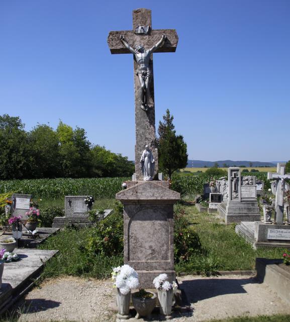 A temető gyepes, műkő sírkövei szabályos sorokban, szorosan egymás