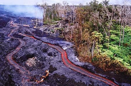 Lava stream deepening it's channel by building levees on the banks