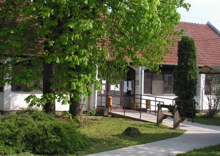 Ebben a növényzet is sokat segít, de az épület megformálása, anyghasználata, tömege, és a hagyományokon alapuló tornácos kialakítása
