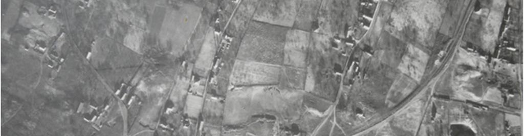Az 1950-es légifotón a község gyárterülethez legközelebb eső része, a későbbi lakótelep térsége látható. Az utcák nyomvonala kialakulóban, a lakóépületek elhelyezkedése hézagos.