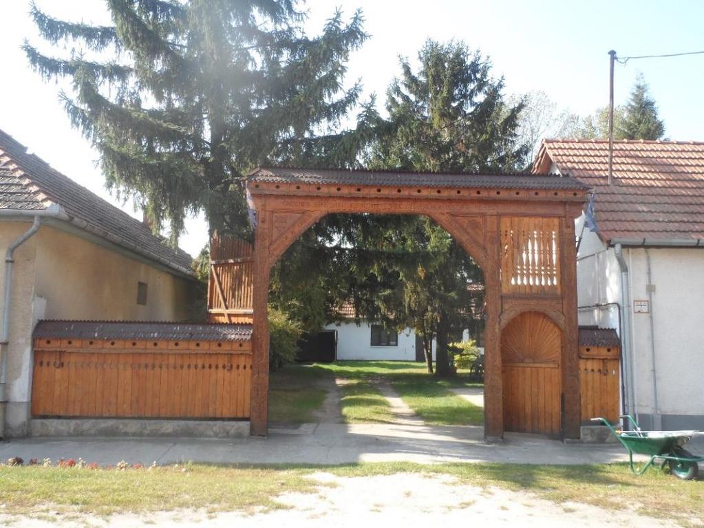 ) az erdélyi testvértelepülés által ajándékozott kapu, amit a polgármesteri hivatal épületénél állítottak fel.