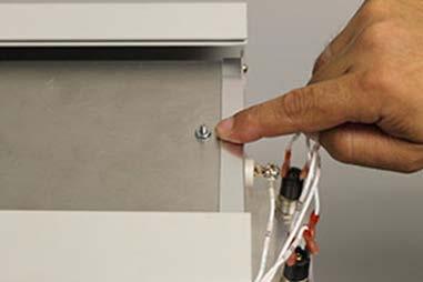 6. Locate the two reflector screw nuts (front and back) on the top of the heater housing assembly.