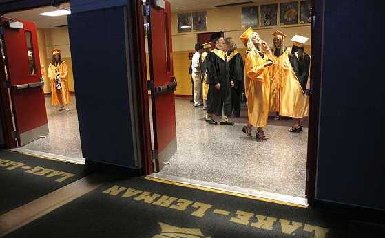 LAKE-LEHMAN HIGH SCHOOL FOR THE TIMES LEADER/CHARLOTTE BARTIZEK Sara Hagenbach and Amber Hartman showing off her decorated graduation cap.