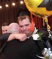 Michael Wademan gives his stepfather Tom Croghan a warm embrace after the ceremony.
