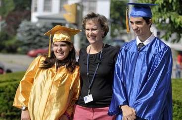 McGavin. PETE G. WILCOX/THE TIMES LEADER Class president Adam McGahee (right) leads his classmates in a cheer before turning over the tassels on their caps at the June 16 commencement.