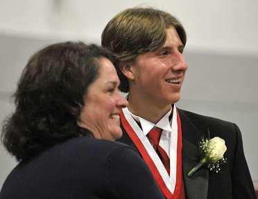 WILCOX/THE TIMES LEADER Valedictorian Joseph McGraw is presented with the Eckley B. Coxe Jr.