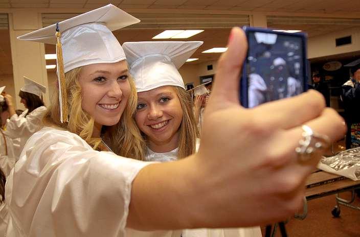 Chelsea Smith passes time using her cellphone while