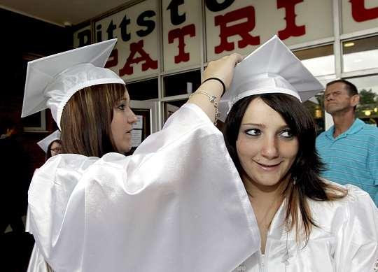 PITTSTON AREA HIGH SCHOOL PHOTOS FOR THE TIMES LEADER/BILL TARUTIS Nicole Pitts, left, adjusts the mortarboard of classmate Alisa Decker before the June 17 graduation outside Pittston Area High