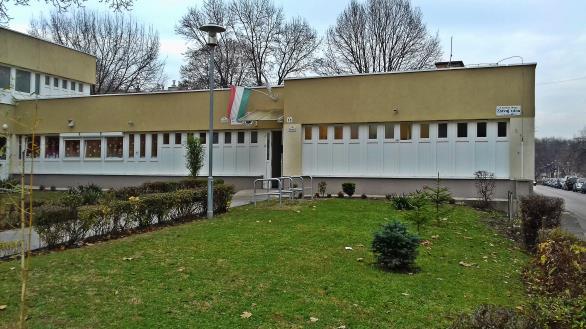A Harmat utcai lakótelepen négy és kilencemeletes lakótelepi épületek zárják el az intézményt a főúttól és annak zajától.