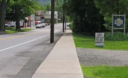 There is a pedestrian crossing sign, but no painted crosswalk at the post office (a major pedestrian destination).