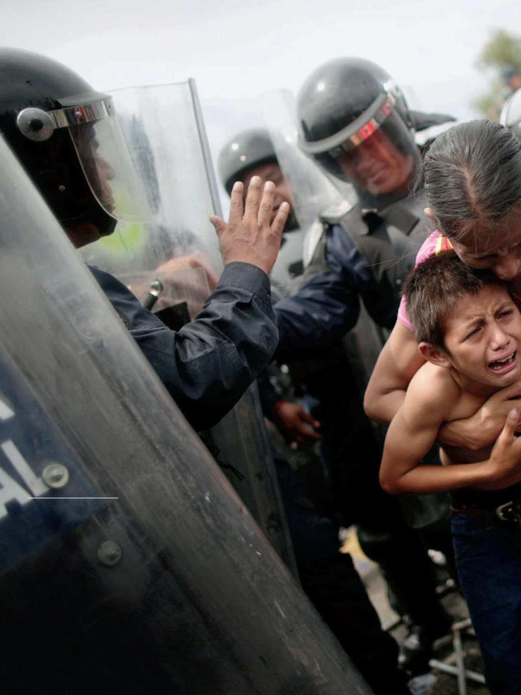 LightBox Seeking shelter A Honduran woman shields her child in Ciudad Hidalgo, Mexico, on Oct. 19, after their fellow migrants stormed a border checkpoint there in order to cross over from Guatemala.