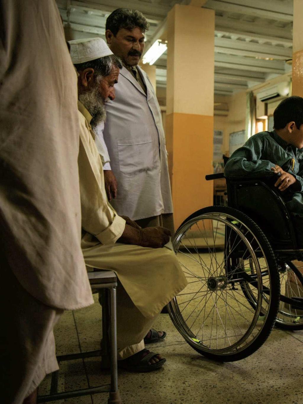 Abdul Rashid watches a patient practice with a